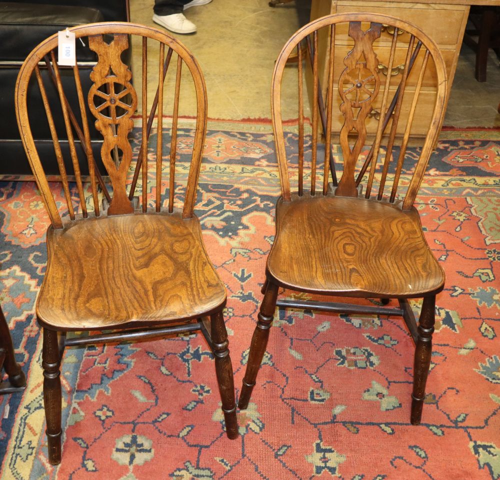 A set of four reproduction elm and beech Windsor wheelback dining chairs